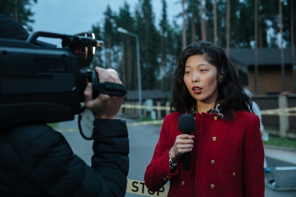 a woman in red holding a microphone