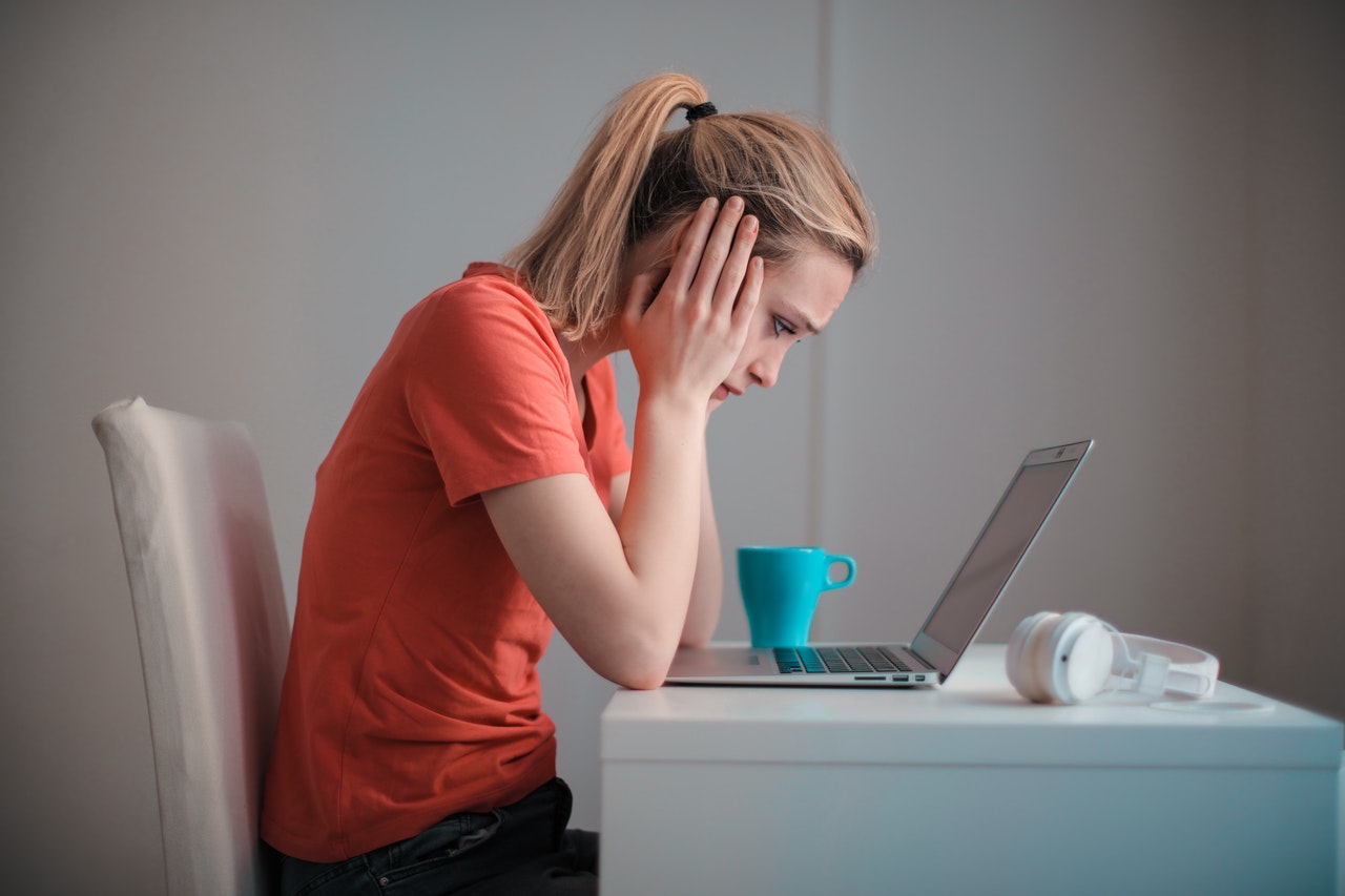 a troubled woman using a laptop 