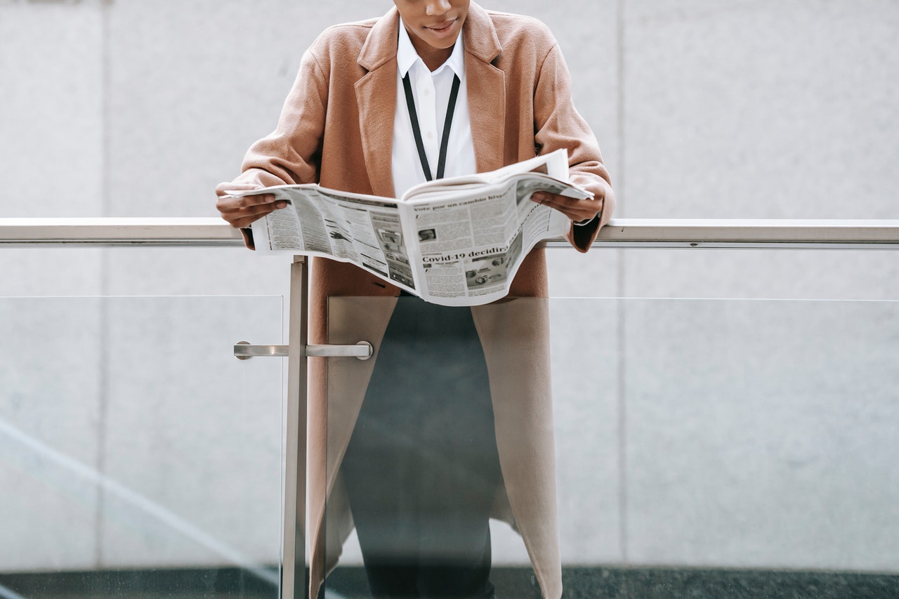 a woman reading a newspaper